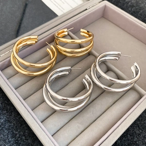 Close-up of gold and silver triple-layered hoop earrings in a jewelry box
