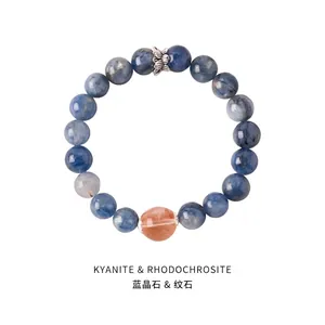 Detailed shot of azurite beaded bracelet with silver wing charm and orange accent stone