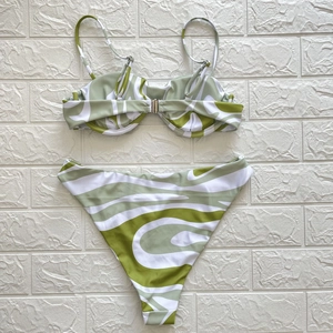 Detailed view of green and white abstract pattern on bikini top with underwire support
