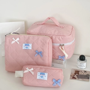 Three-piece set of pink quilted storage bags with cute bows and diamond stitching detail