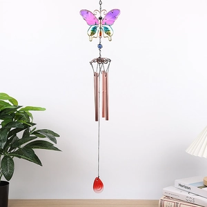Detail of metal wind chime with colorful butterfly design and hanging red teardrop pendant