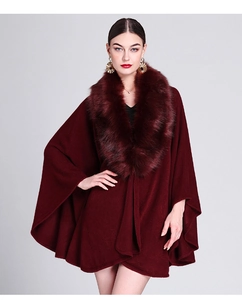 Detail shot of wine red knitted shawl with high-quality faux fur collar and soft texture