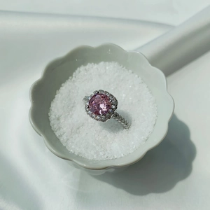 Macro shot of S925 silver ring featuring pink halo setting zircon and pavé band details
