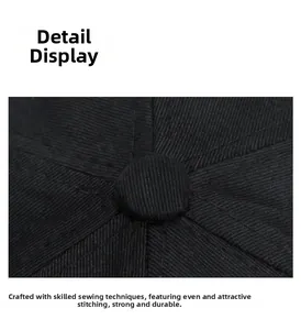 Close-up of black cotton twill cap top button with reinforced stitching detail