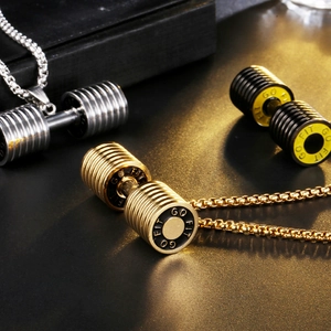 Detailed close-up of dumbbell pendants in silver, gold, and black with GO FIT engraving