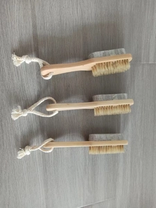 Detail of wooden bath brush with natural bristles and pumice stone for exfoliation