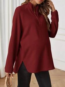 Women's burgundy fleece pullover with half-zip collar and loose maternity-friendly fit