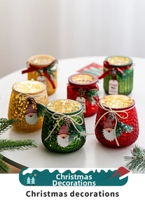 Close-up of LED glass jars with pine cones and tags for Christmas table decor