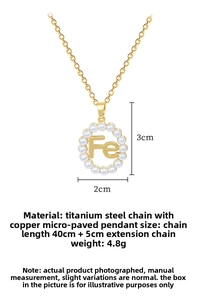 Detailed specs of gold titanium steel necklace with pearl pendant and Fe lettering