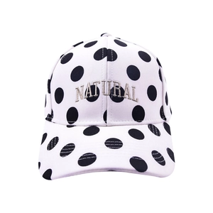 White baseball cap with black polka dots and Natural gold embroidery on front panel