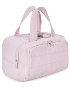 Detailed shot of pink quilted nylon toiletry bag featuring dual zipper compartments and handles