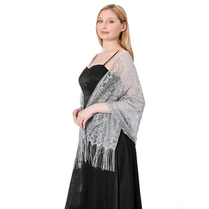 Detail of grey lace shawl with vintage floral patterns and long tassels on black dress