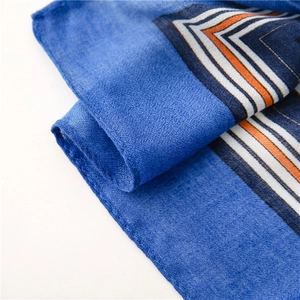 Detail of royal blue cotton-linen shawl showing soft fabric texture and striped border