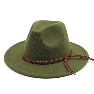 Detail of olive green wool fedora hat featuring a brown braided band and tassel accent