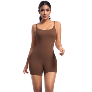 Detail of slim straps and smooth brown fabric on a form-fitting yoga bodysuit