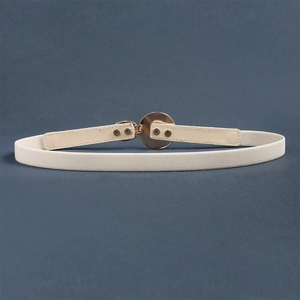 Elastic waist belt for women with elegant gold round buckle on dark blue textured background