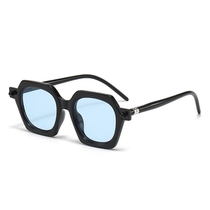 Retro chunky black polygon sunglasses with light blue lenses and ball accents
