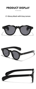 Detail view of retro round sunglasses in glossy black with gold rivet accents
