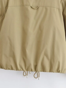 Détail de l'ourlet de veste kaki avec cordon de serrage réglable et embouts métalliques