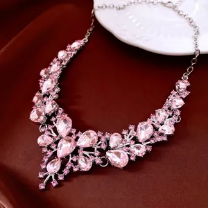 Elegant silver necklace featuring large pink water drop crystals and rhinestones decoration