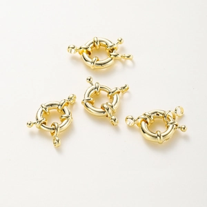 Detailed macro view of four gold-plated sailor clasps for DIY jewelry making