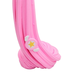 Close-up of stretchy pink butter slime with star wing resin charms for sensory play