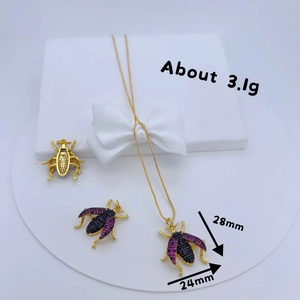 Macro detail of gold-plated insect pendant with dimensions 28mm x 24mm and cubic zirconia