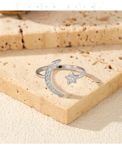 Detailed close-up of a silver moon and star adjustable ring with shimmering stones