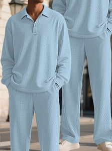 Detail of light blue men's knitted polo set featuring a refined jacquard diamond texture