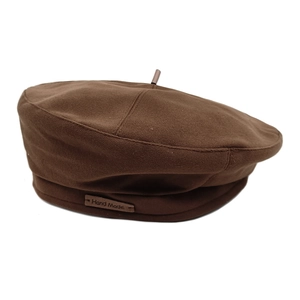 Retro brown wool beret for women with Hand Made leather label on plain white background