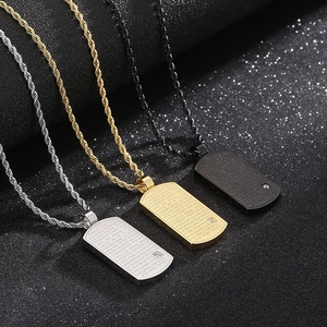 Gros plan de trois colliers dog tag en acier argent, or et noir avec gravure de texte de prière