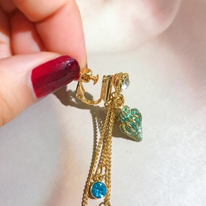 Golden clip-on earrings with green shell and sparkling rhinestone tassels for non-pierced ears