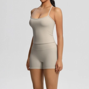 Detail of khaki two-piece yoga set featuring thin strap tank top and high waist shorts
