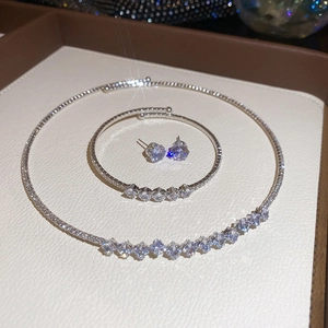 Exquisite silver necklace bracelet and stud earrings set displayed on a jewelry box