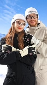 Detail shot of winter ski gloves with waterproof shell and warm fleece lining shown outdoors