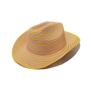Close-up of woven straw fedora hat featuring yellow and purple spiral stripes texture