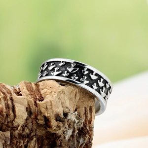 Detail shot of a vintage silver and black mushroom ring on a rustic wood background