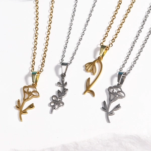 Detail of four stainless steel birthday month flower necklaces in gold and silver finishes