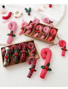 Detailed view of Scottish plaid fabric candy cane ornaments with red berries for Christmas