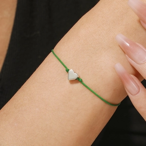 Green woven rope heart bracelet with silver charm for Saint Patrick's Day fashion