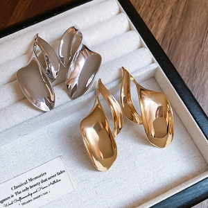 Modern irregular fluid metal earrings with high-polish mirror finish in gold and silver