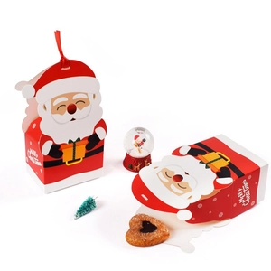 Christmas gift boxes with Santa Claus motifs and red ribbons for candies and treats