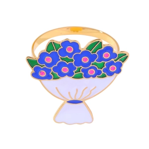 Detailed close-up of a gold alloy napkin ring featuring a blue enamel flower bouquet