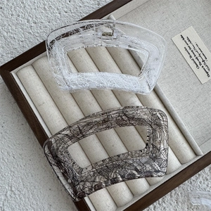 Detail of creative hollow geometric hair claws with transparent lace mesh texture