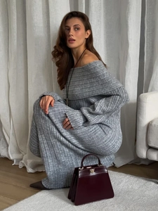 Detailed close-up of grey rib-knit off-shoulder maxi dress with elegant long sleeves