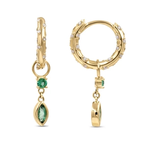 Detail of 18K gold hoop earrings with white pavé stones and green gem pendants