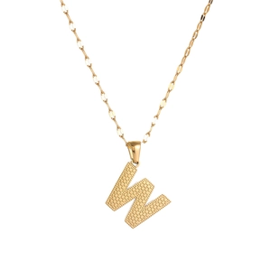 Close-up of golden letter W pendant with detailed metallic texture on a fine chain