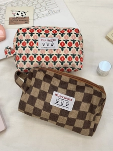 Corduroy travel cosmetic bags featuring floral and checkerboard patterns with carry handles