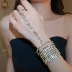 Detailed macro view of a silver-tone multi-layer rhinestone ring-to-wrist slave bracelet
