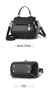 Detail view showing the back zipper pocket and gold protective studs on the black bucket bag